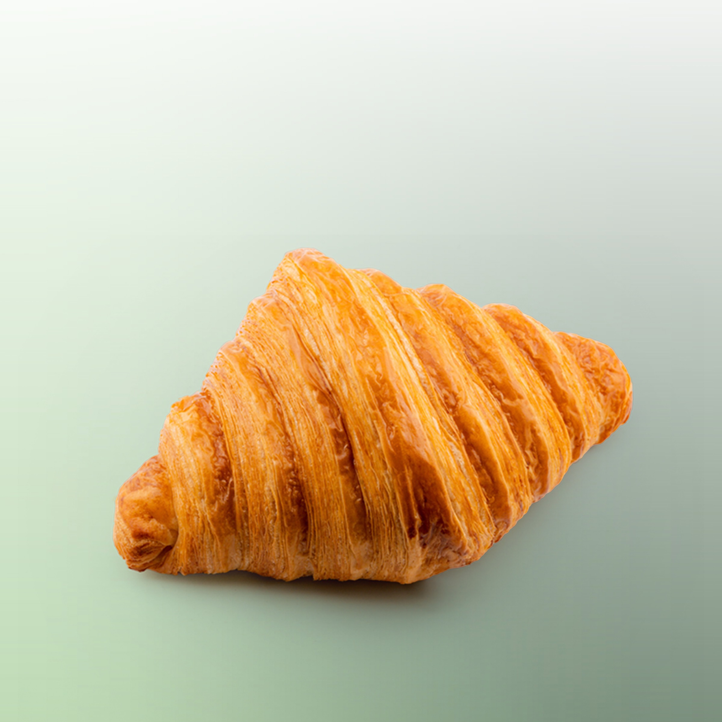 Close-up of the crisp golden layers of a hy Bakery croissant